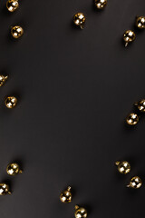 Christmas composition gold balls on a black background. Decorations for the New Year.