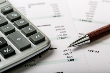 Calculator, Pen and Financial Figures