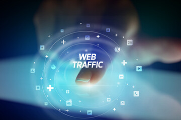 Finger touching tablet with social media icons and WEB TRAFFIC