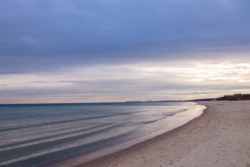 Obraz premium beautiful calm sea waving in the early morning on a golden sandy beach