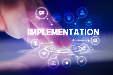 Finger touching tablet with web technology icons and IMPLEMENTATION inscription, web technology concept