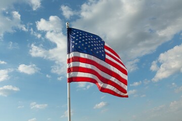 American Flag Waving Against Blue Sky