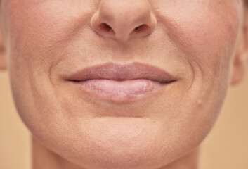 Fototapeta premium Beautiful female face studio shot on a beige background