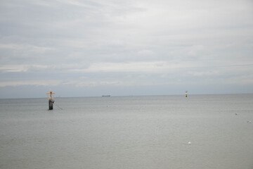 a lonely sea buoy protruding from the steel, calm sea