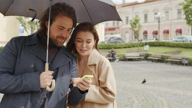 young couple in the rain chooses a cozy place for dinner