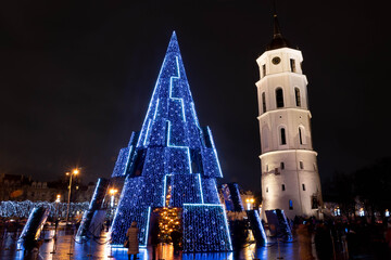 Fototapeta na wymiar Beautiful Christmas tree in Vilnius Cathedral square, Lithuania, Europe, no market and events due to Covid or Coronavirus pandemic 