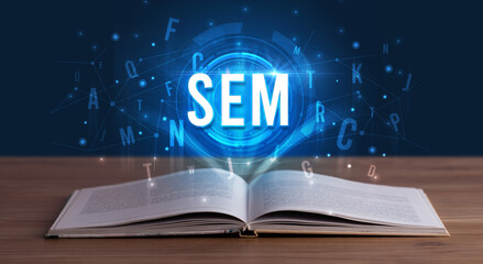 SEM inscription coming out from an open book, digital technology concept