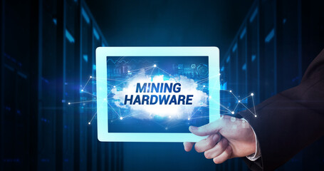 Young business person working on tablet and shows the inscription: MINING HARDWARE