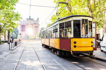 Naklejka na ściany i meble Arch of Peace view with nostalgic yellow tram in MILANO, ITALY.