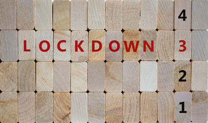 Time to 3rd lockdown. Wooden blocks form the words 'lockdown 3'. Numbers 1, 2, 4. Beautiful wooden background. Covid-19 pandemic and medical concept.