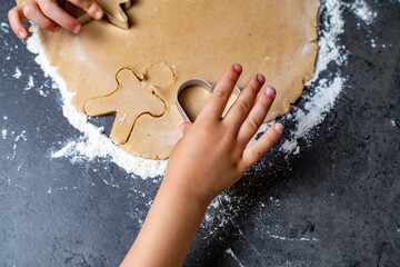 christmas and new year holidays, mom and children prepare gingerbread cookies