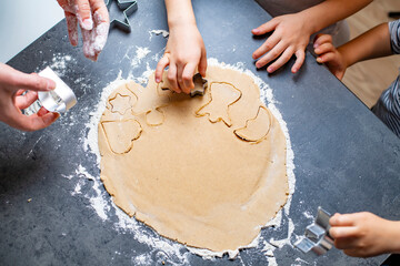 christmas and new year holidays, mom and children prepare gingerbread cookies