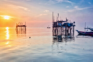 Beautiful view on sunrise with wooden boat as a subject at Kenjeran beach,Surabaya.Indonesia