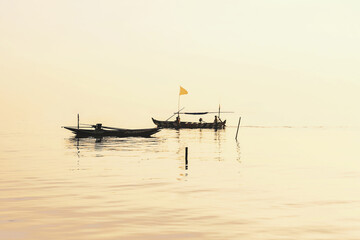 Beautiful view on sunrise with wooden boat as a subject at Kenjeran beach,Surabaya.Indonesia