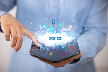 Businessman holding a foldable smartphone with SCIENCE inscription, technology concept