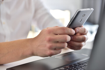 Businessman hand using mobile phone.