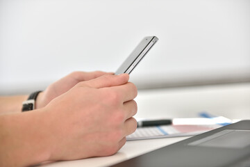 Fototapeta premium Businessman hands using smart phone.