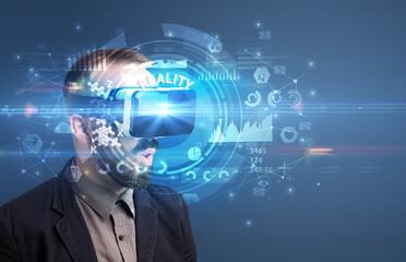 Businessman looking through Virtual Reality glasses with REALITY inscription, innovative technology concept