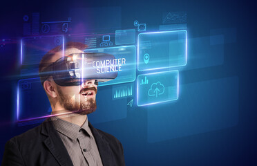 Businessman looking through Virtual Reality glasses with COMPUTER SCIENCE inscription, new technology concept
