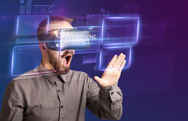Businessman looking through Virtual Reality glasses with ENGINEERING SCIENCE inscription, new technology concept