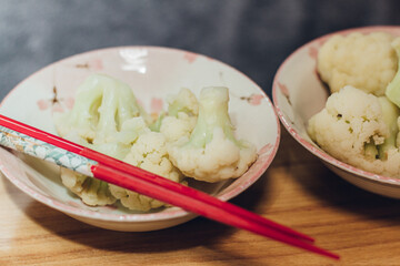 Served Cauliflower in bowl with chopsticks at dinner in Japan