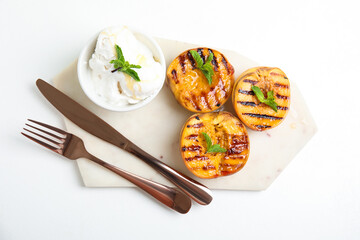 Delicious grilled peaches with ice cream and honey on white table, top view