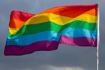 Rainbow flag on background of the sky