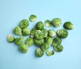 Fresh Brussels sprouts on light blue background, flat lay
