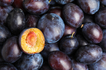 Many delicious ripe plums as background, closeup