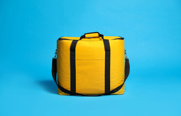 Modern yellow thermo bag on light blue background