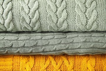 Stack of soft warm plaids as background, closeup