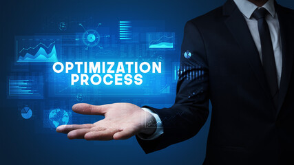 Hand of Businessman holding OPTIMIZATION PROCESS inscription, business success concept