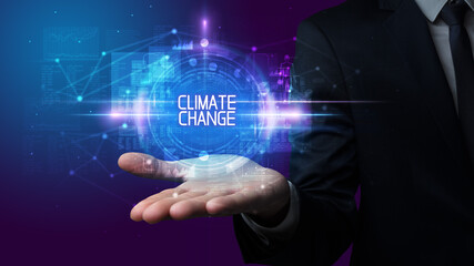 Man hand holding CLIMATE CHANGE inscription, technology concept