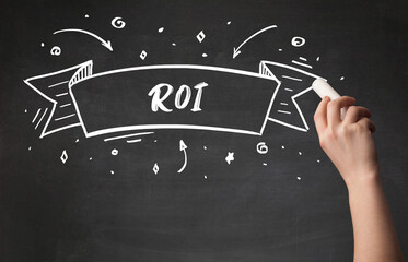 Hand drawing ROI abbreviation with white chalk on blackboard