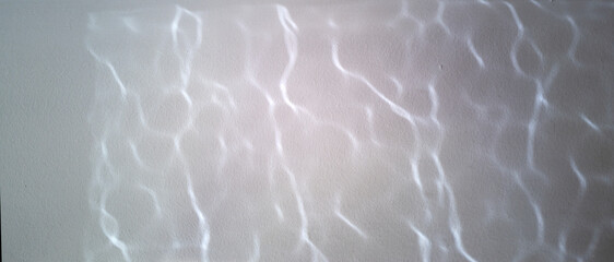 Water reflections on a grey background, squiggly lines, abstract pattern