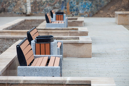 Autumn, 2013 - Vladivostok, Primorsky region - Urban street brown benches close up. Street bench and marble urn in the park.