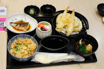 Japanese foods composed of fried rice with egg and garlic,fish,fried shrimps,hot soup and poached eggs in cup