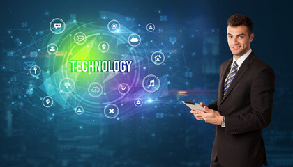 Businessman thinking in front of technology related icons and TECHNOLOGY inscription, modern technology concept