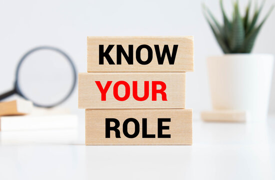 KNOW YOUR ROLE text on a wooden cubes on a white background