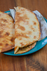 Manakish Zaatar | Lebanese Traditional Breakfast Thyme Pastry in plate over natural wood table