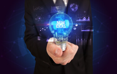Businessman holding lightbulb with NEW IDEAS inscription, Business idea concept