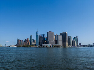 Sunny view of skyscrapers in Financial District, Manhattan from Hudson River with clear sky