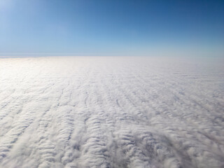 Aerial view above layer of altocumulus clouds with unique texture at midday - obrazy, fototapety, plakaty