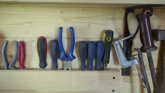 Well organizied construction carpentry tools on board in woodworker workshop. DIY concept.