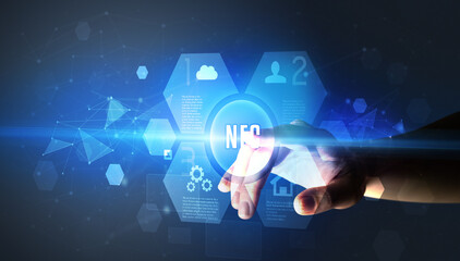 Hand touching NFC inscription, new technology concept