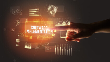 Hand touching SOFTWARE IMPLEMENTATION inscription, new business technology concept