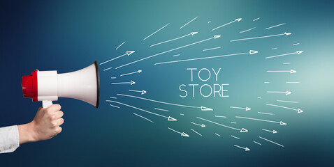 Young girl screaming to megaphone with TOY STORE inscription, shopping concept