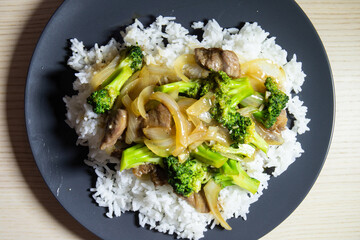 Beef and broccoli stir fry on top of rice.