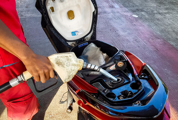 Refueling gasoline on the motorcycle. Fuel station content