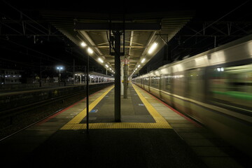 Kyoto,Japan-November 21, 2020: A train passing JR Yamashina station at dusk in Kyoto
